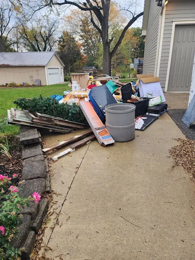 Dumpster being loaded with debris for Roofing Dumpster Rental in Ashland